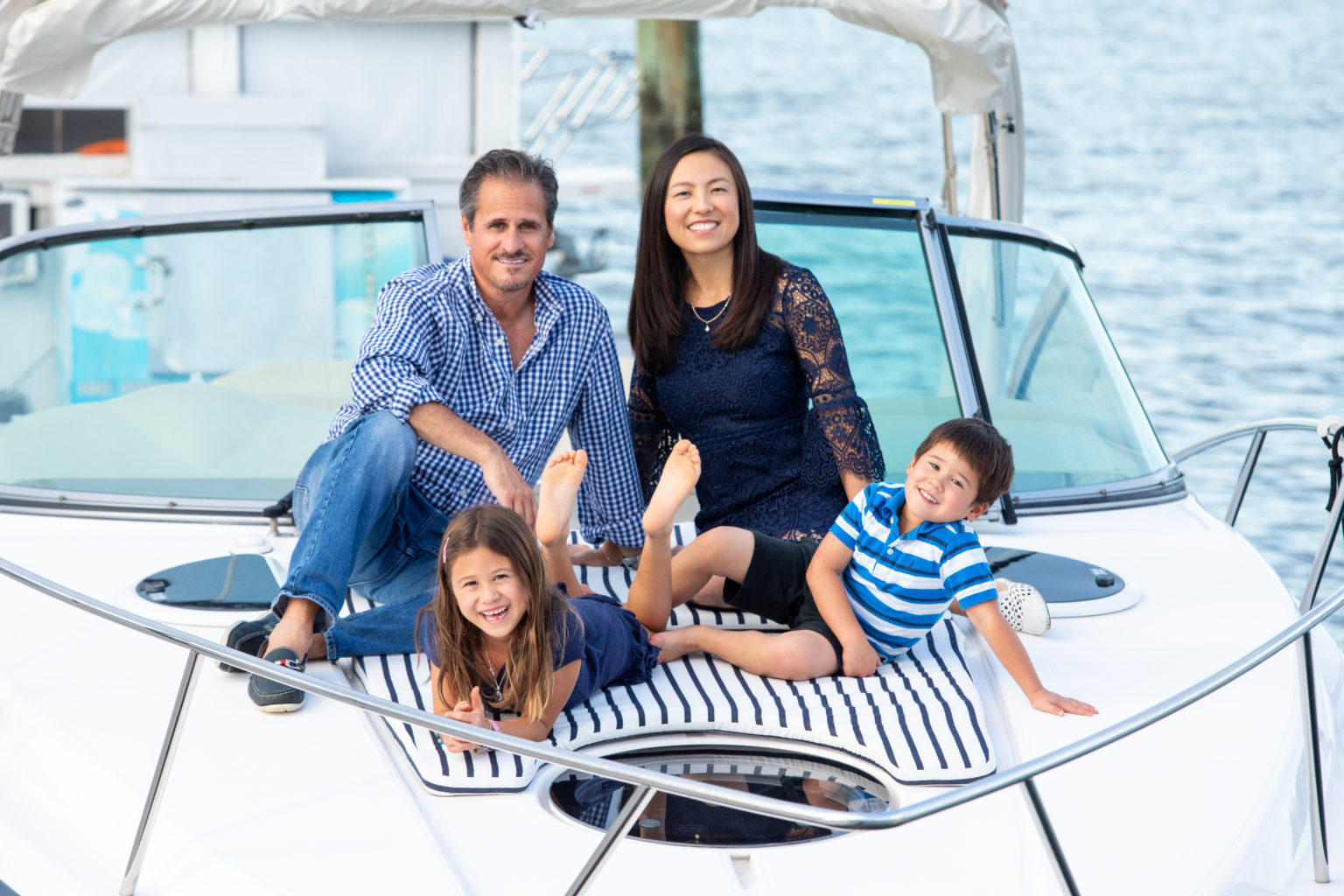 Family photographed by a Long Island Family Photographer on a boat