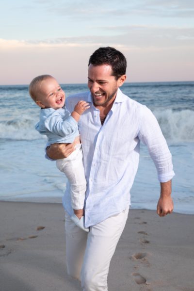 Man and his baby enjoying Cooper's Beach in the Hamptons