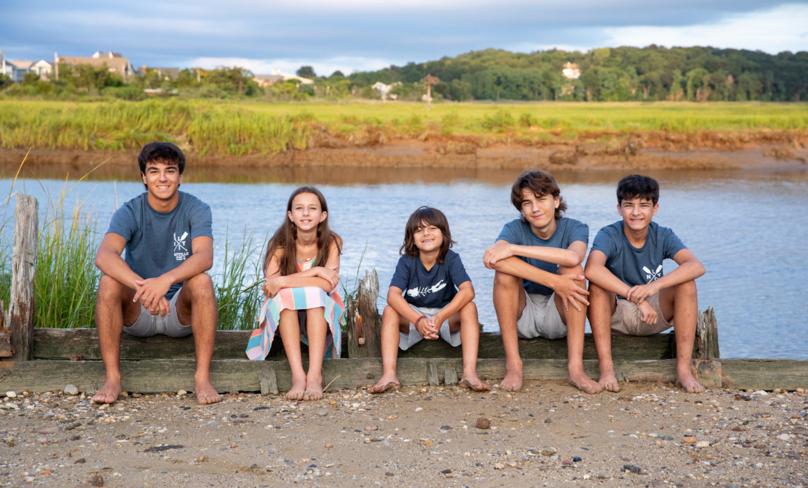 Family photographed on the beach by a NYC family photographer